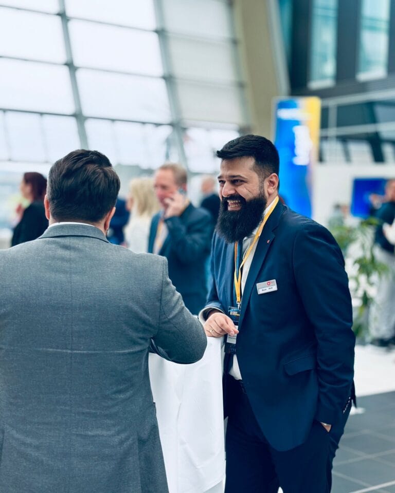 Reza ABdi auf einer Messe im Gespräch über B2B Quality Management